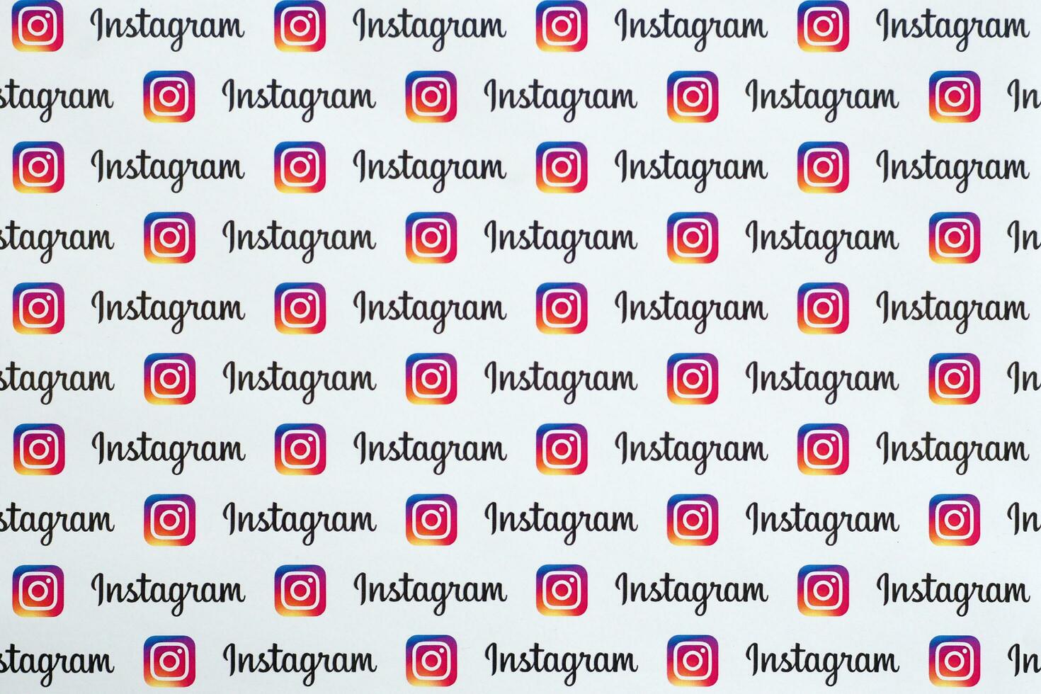 Instagram pattern printed on paper with small instagram logos and inscriptions. Instagram is American photo and video-sharing social networking service owned by Facebook
