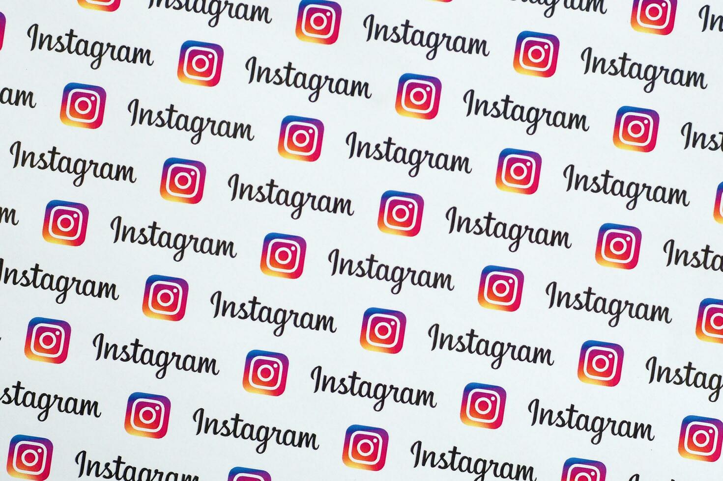 Instagram pattern printed on paper with small instagram logos and inscriptions. Instagram is American photo and video-sharing social networking service owned by Facebook