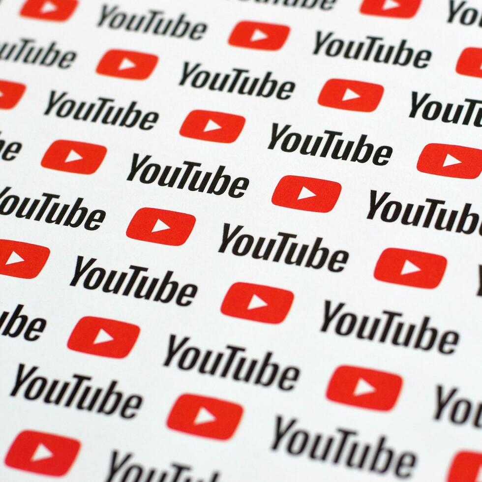 Youtube pattern printed on paper with small youtube logos and inscriptions. YouTube is Google subsidiary and American most popular video-sharing platform photo