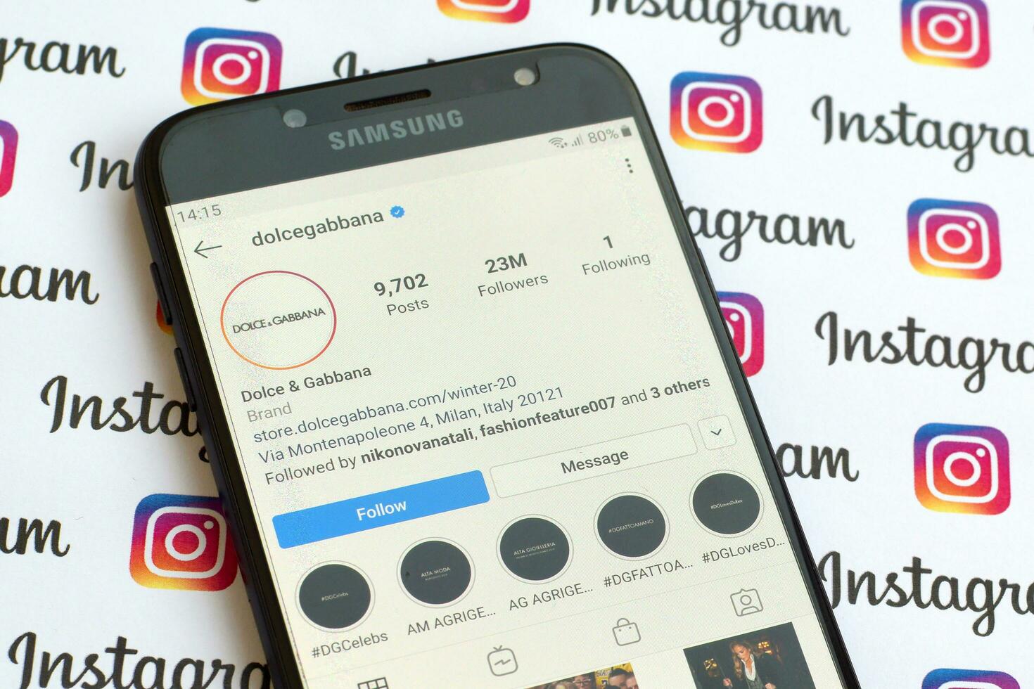 Dolce and Gabbana official instagram account on smartphone screen on paper instagram banner. photo