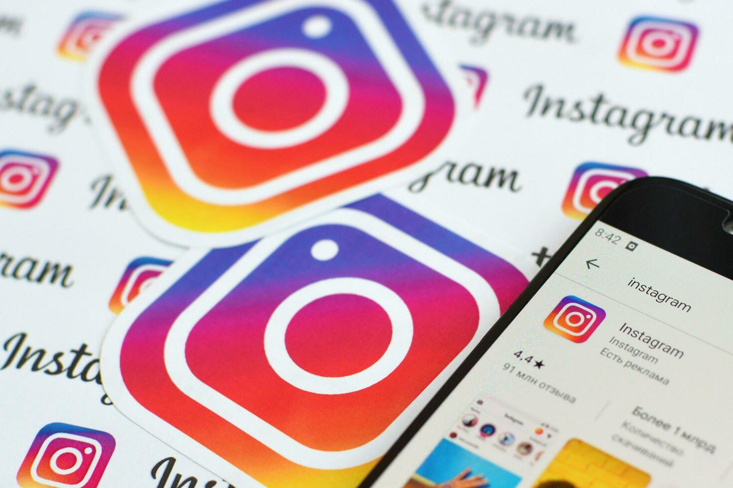 Instagram app on samsung smartphone screen on banner with small instagram logos. Instagram is American photo and video-sharing social networking service by Facebook inc