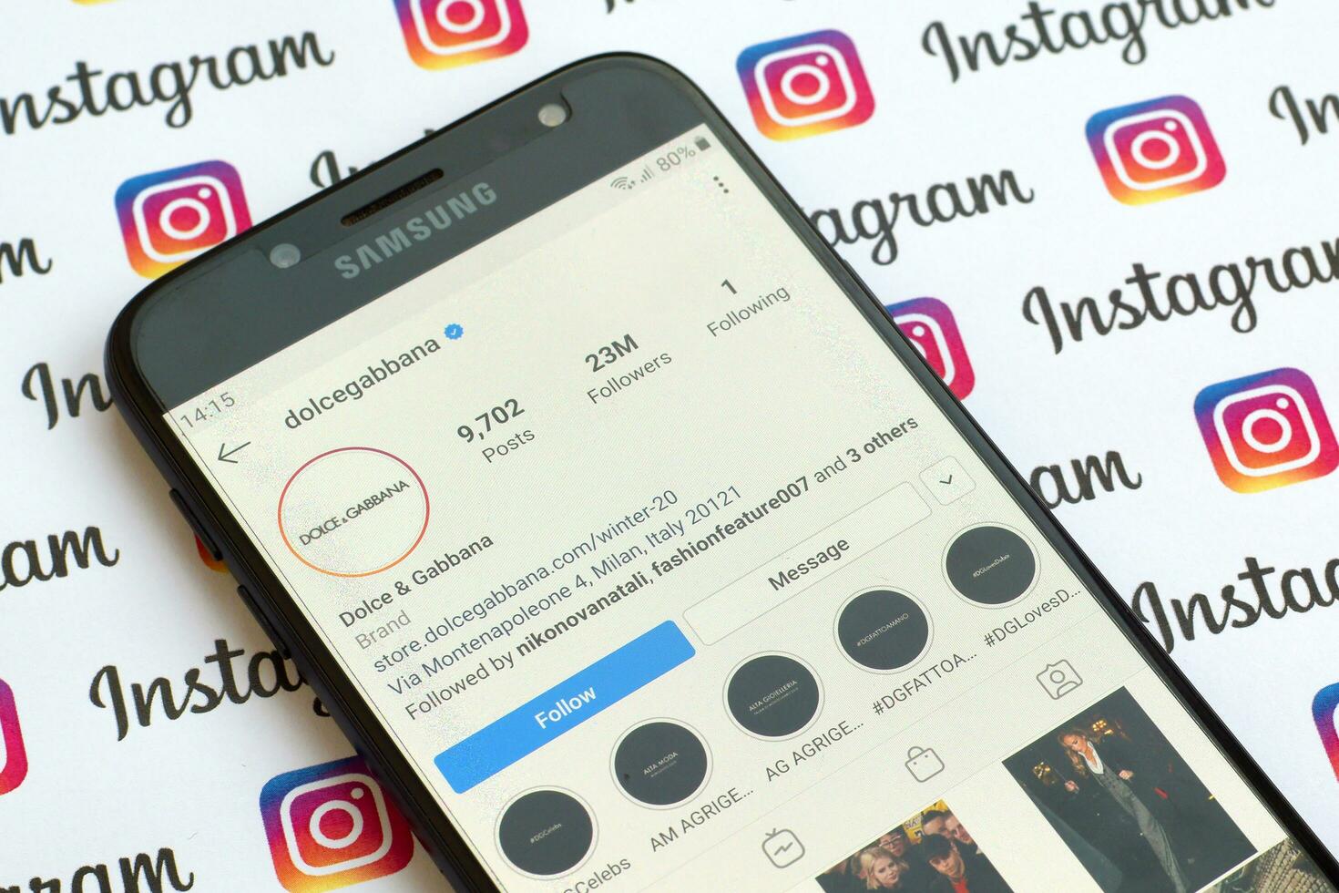 Dolce and Gabbana official instagram account on smartphone screen on paper instagram banner. photo