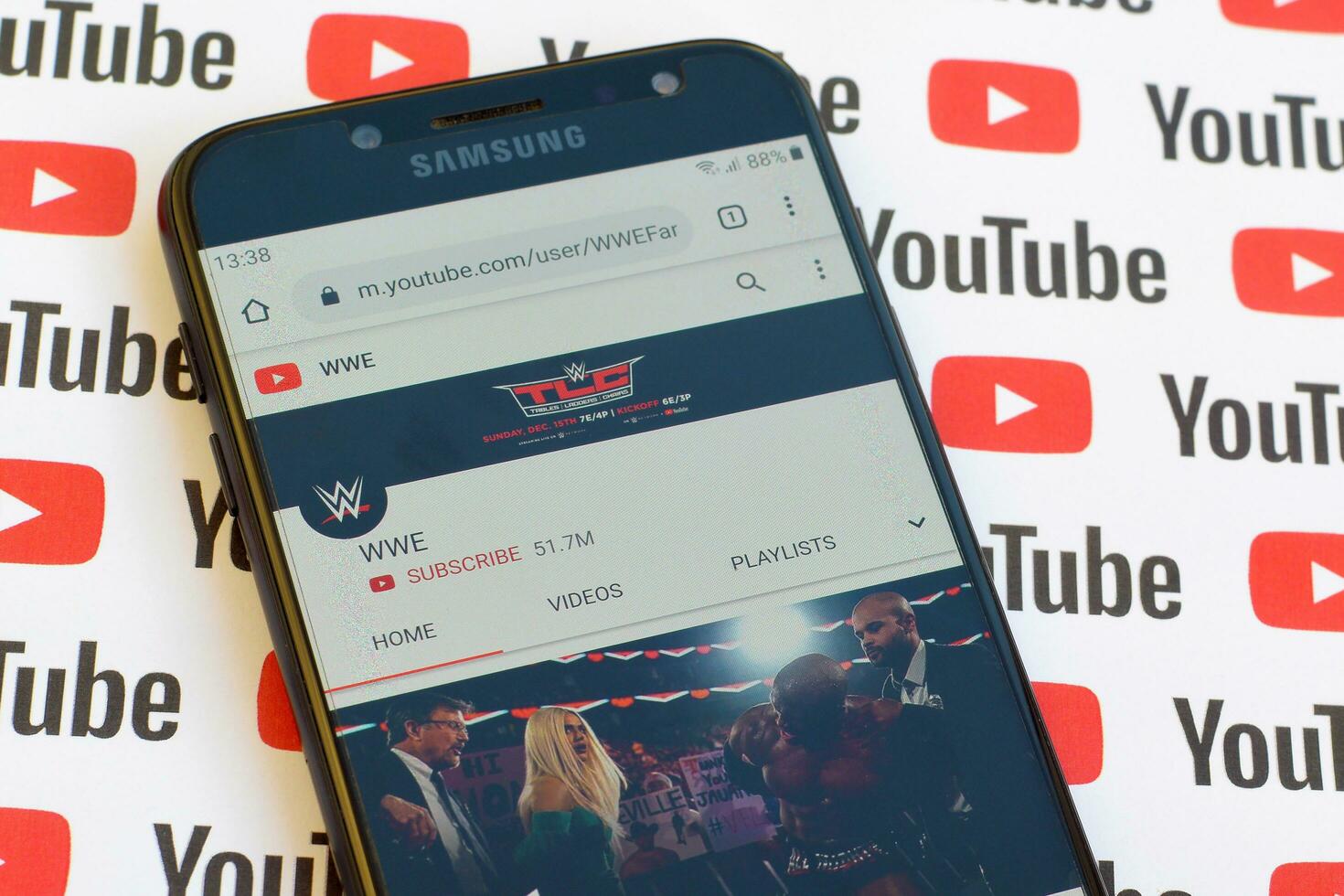 WWE official youtube channel on smartphone screen on paper youtube background. photo