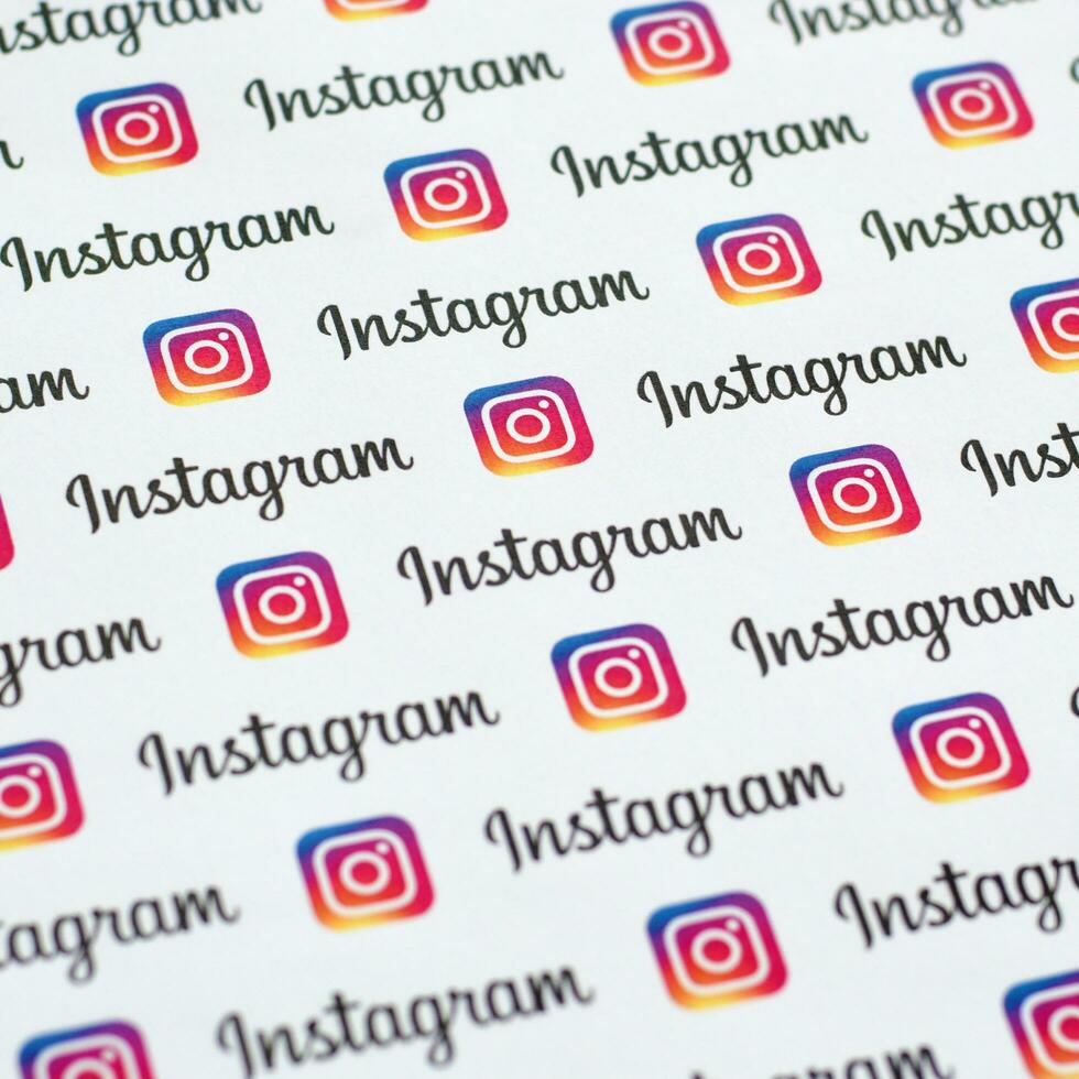 Instagram pattern printed on paper with small instagram logos and inscriptions. Instagram is American photo and video-sharing social networking service owned by Facebook