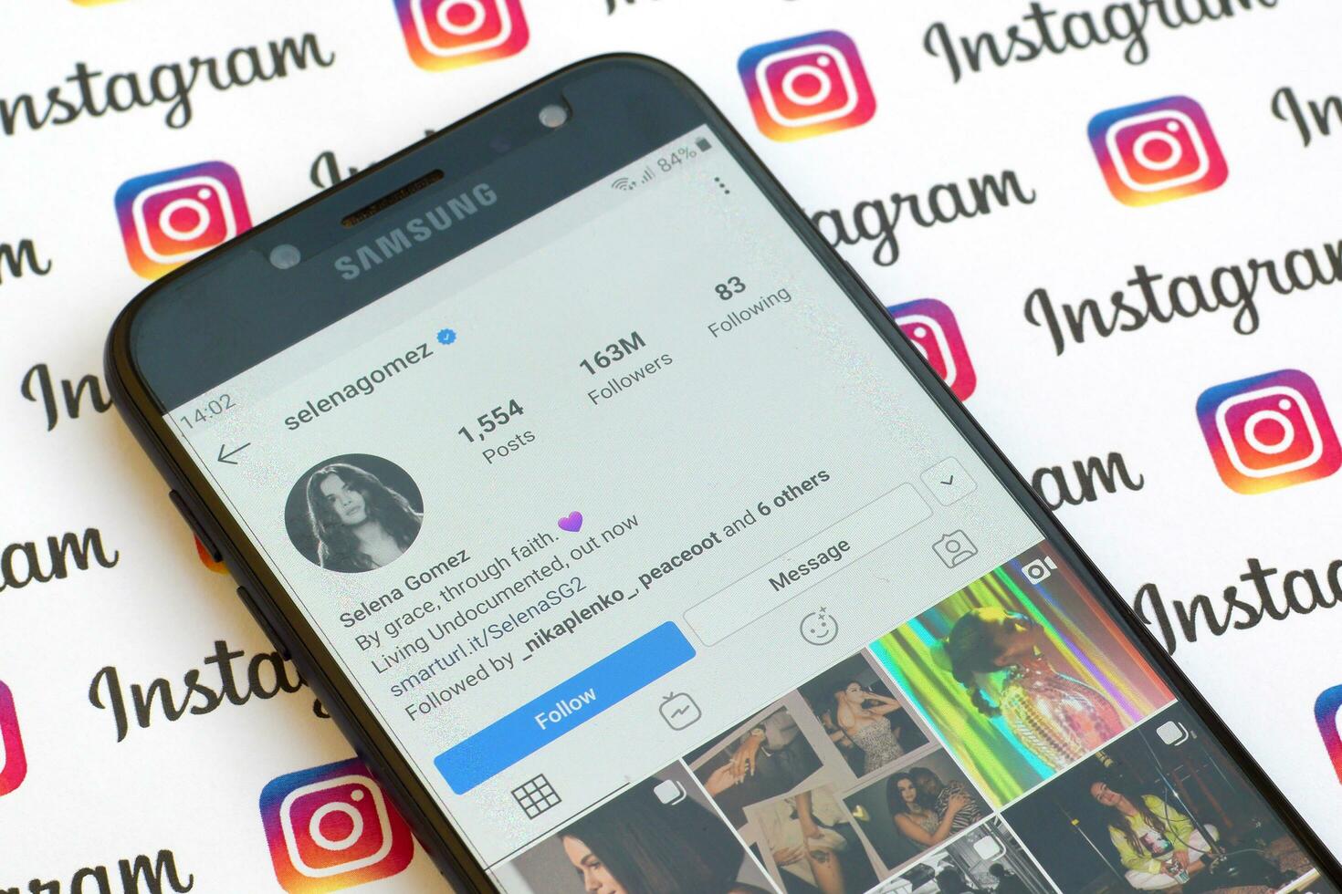 Selena Gomez official instagram account on smartphone screen on paper instagram banner. photo