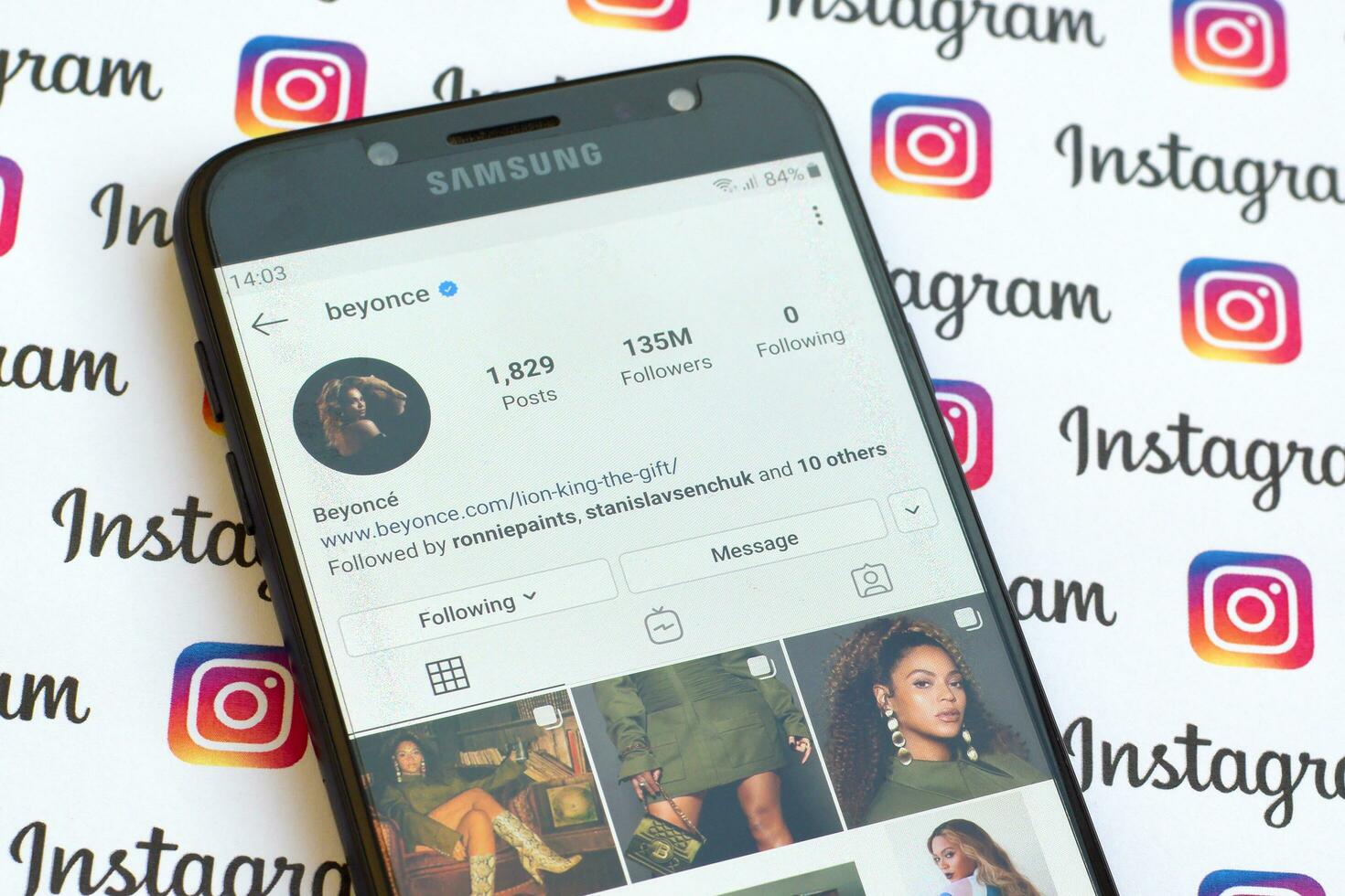 Beyonce official instagram account on smartphone screen on paper instagram banner. photo
