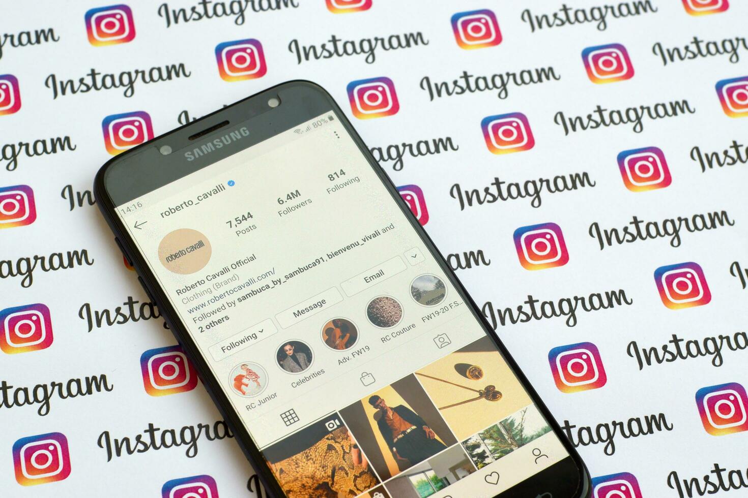 Roberto Cavalli official instagram account on smartphone screen on paper instagram banner. photo