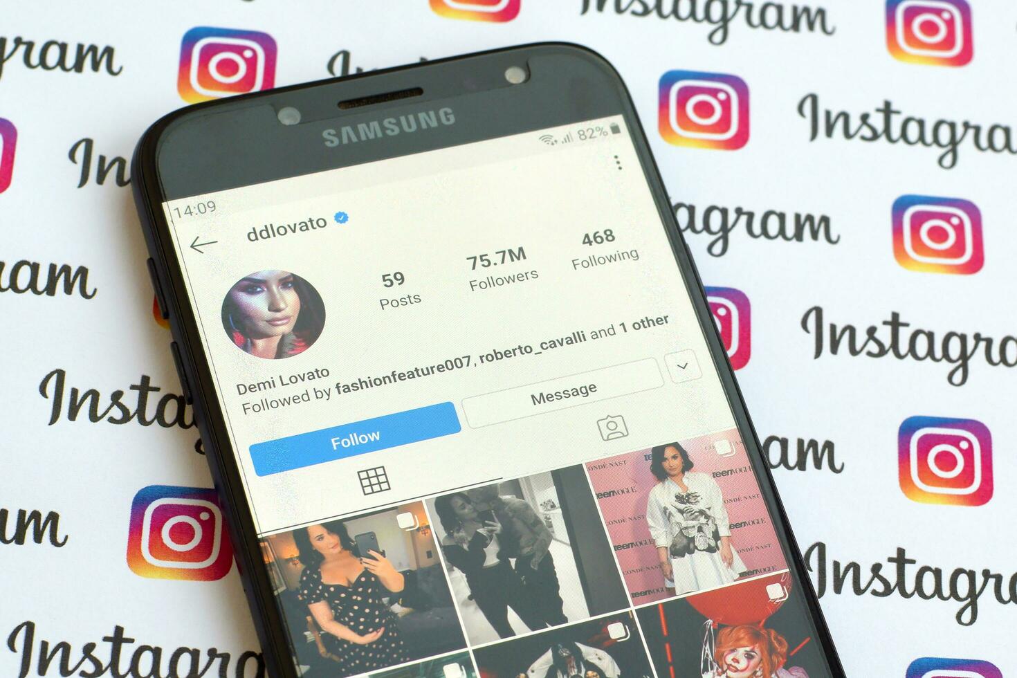 Demi Lovato official instagram account on smartphone screen on paper instagram banner. photo