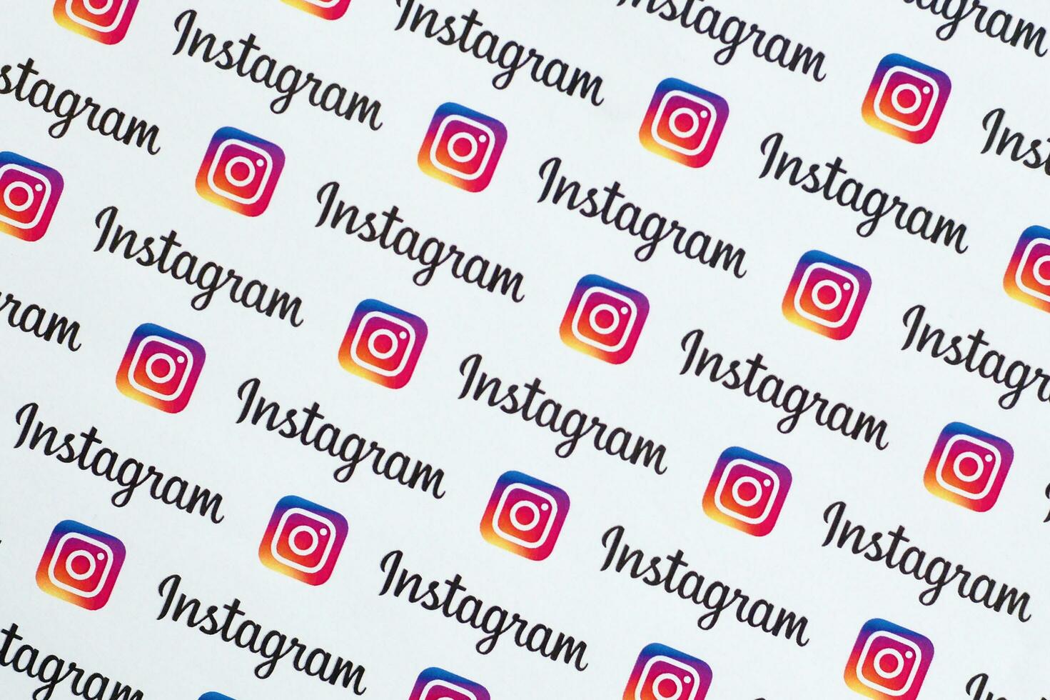 Instagram pattern printed on paper with small instagram logos and inscriptions. Instagram is American photo and video-sharing social networking service owned by Facebook