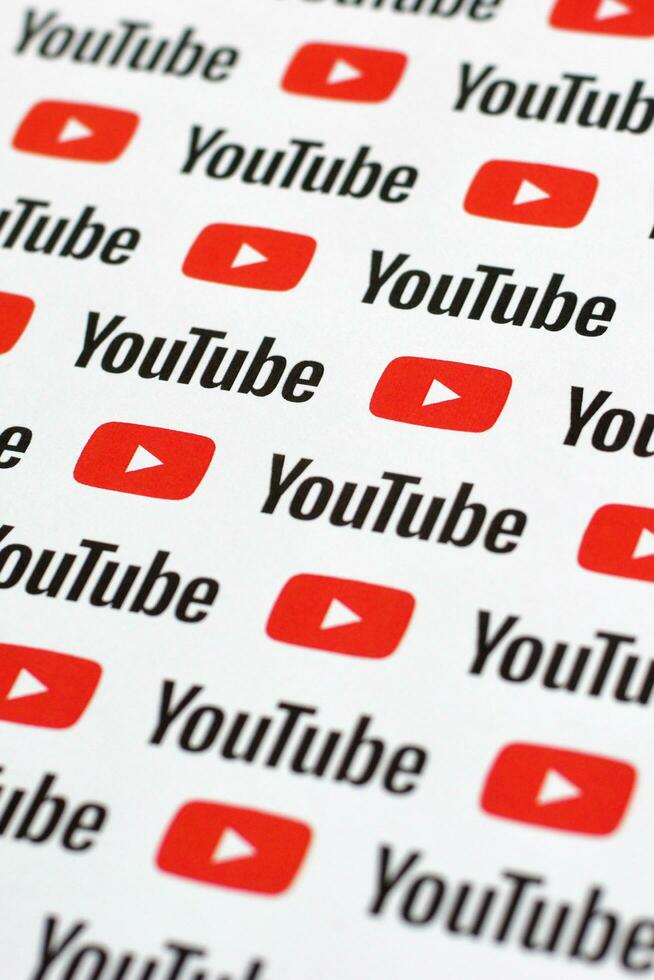 Youtube pattern printed on paper with small youtube logos and inscriptions. YouTube is Google subsidiary and American most popular video-sharing platform photo