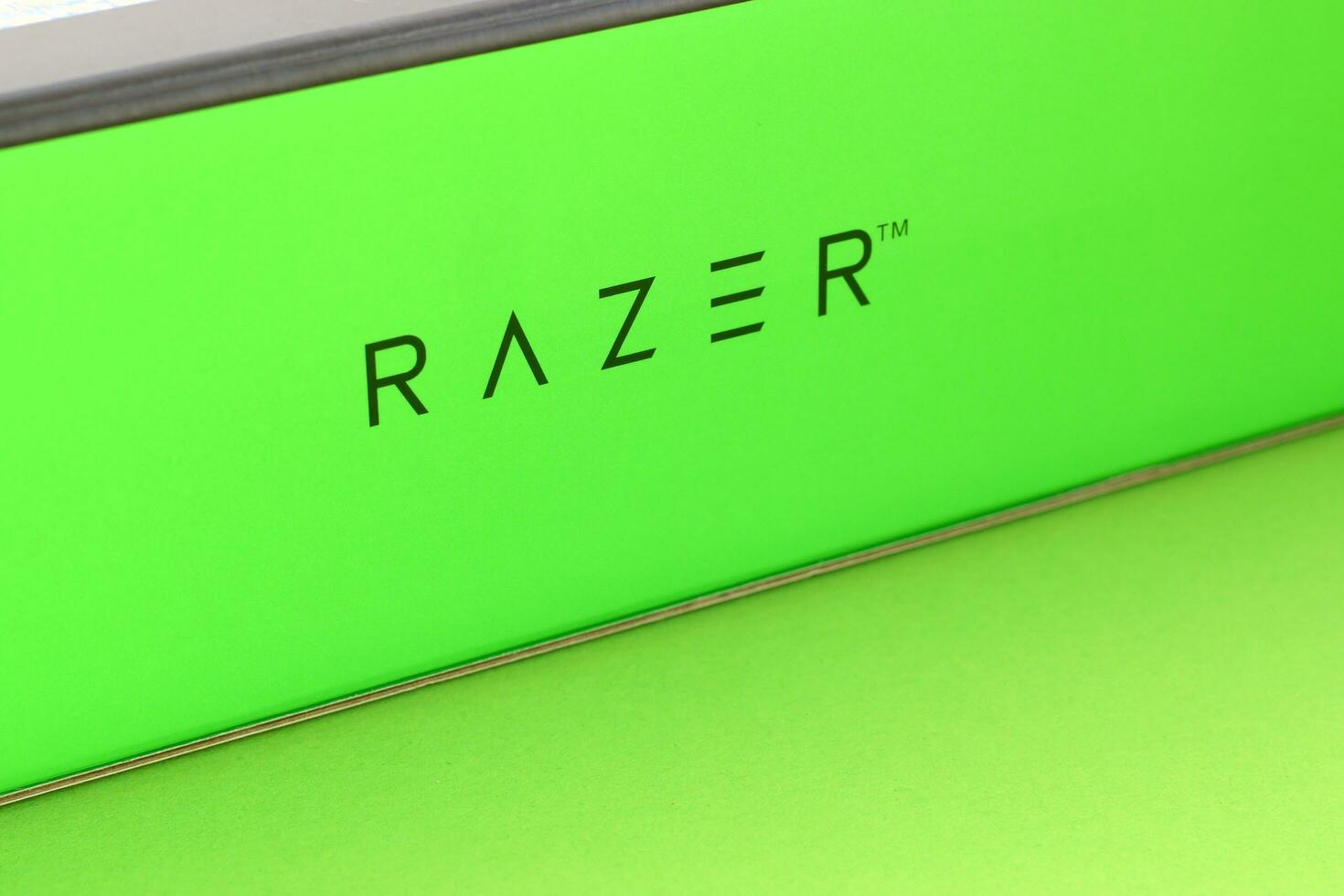 Razer Goliathus Speed Gaming green mouse pad and box with logo. Razer global gaming hardware manufacturing company, as well as an esports and financial services photo