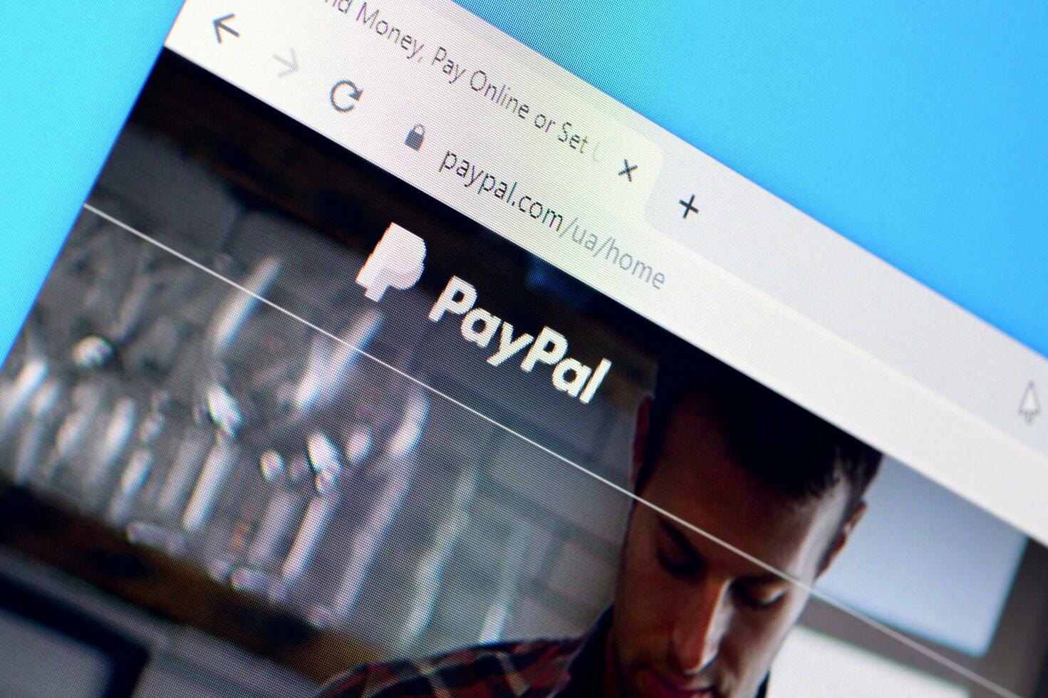Homepage of paypal website on the display of PC, url - paypal.com. photo