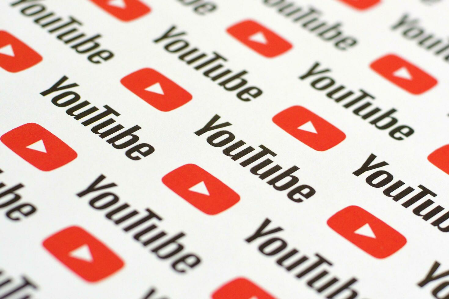 Youtube pattern printed on paper with small youtube logos and inscriptions. YouTube is Google subsidiary and American most popular video-sharing platform photo