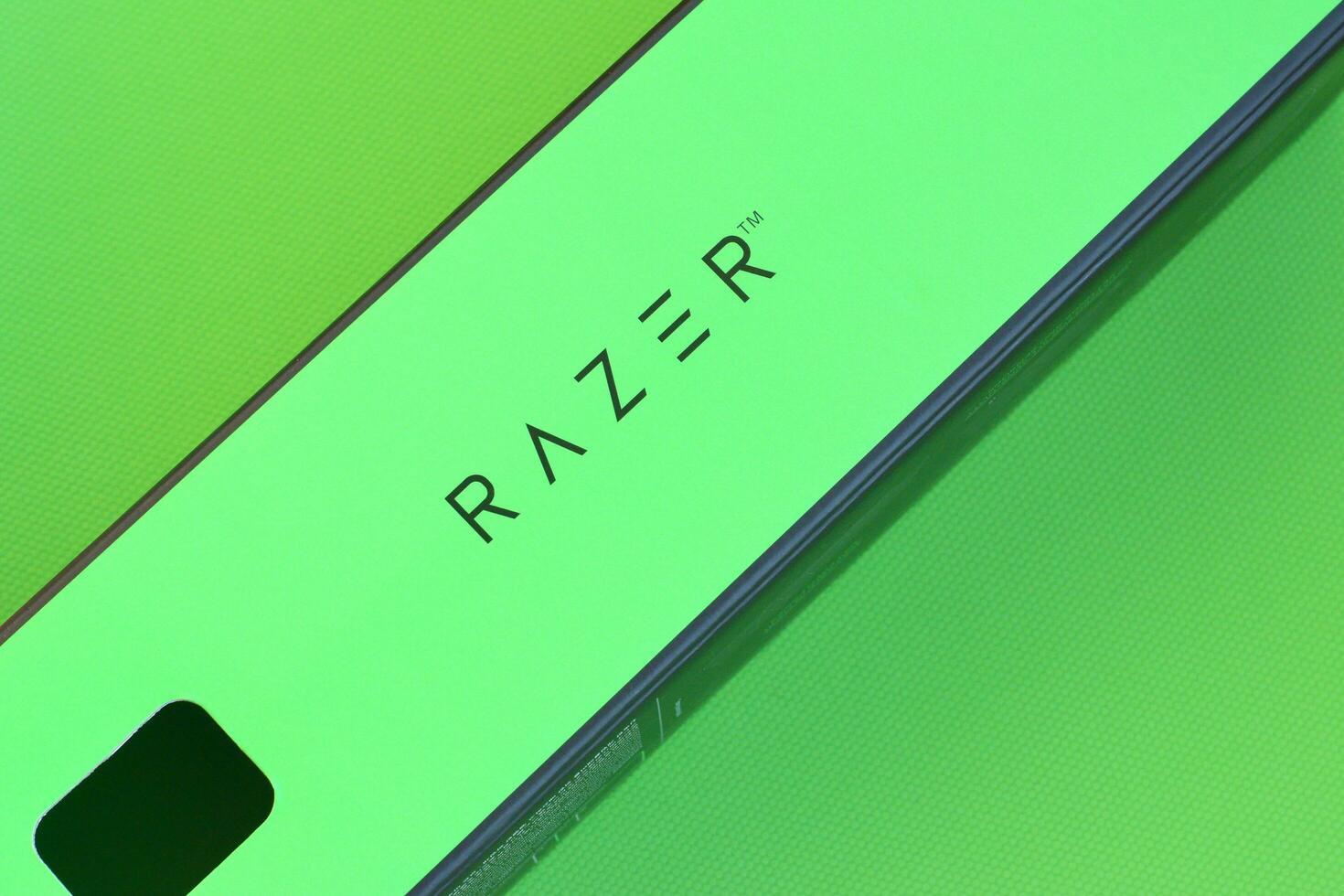 Razer Goliathus Speed Gaming green mouse pad and box with logo. Razer global gaming hardware manufacturing company, as well as an esports and financial services photo