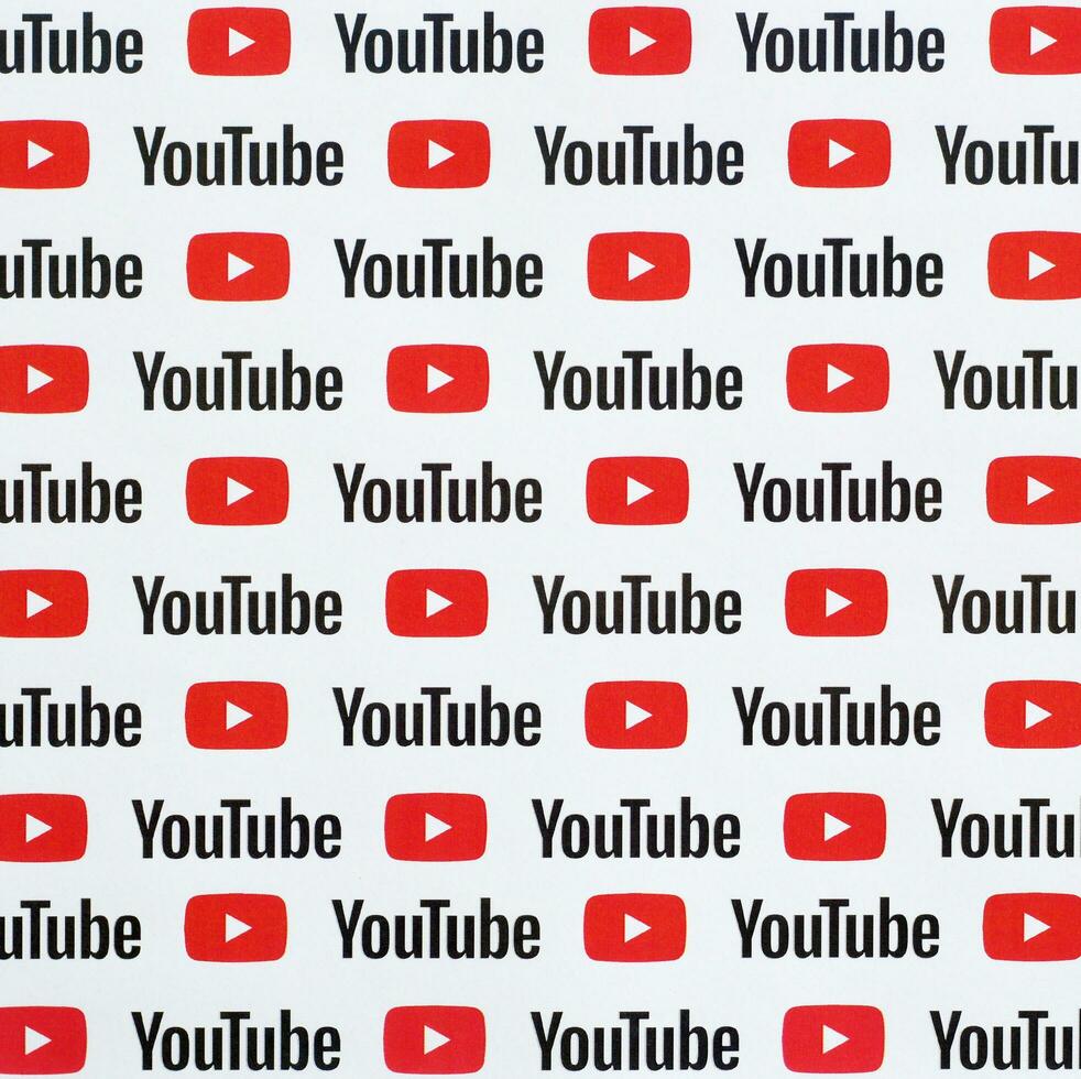 Youtube pattern printed on paper with small youtube logos and inscriptions. YouTube is Google subsidiary and American most popular video-sharing platform photo