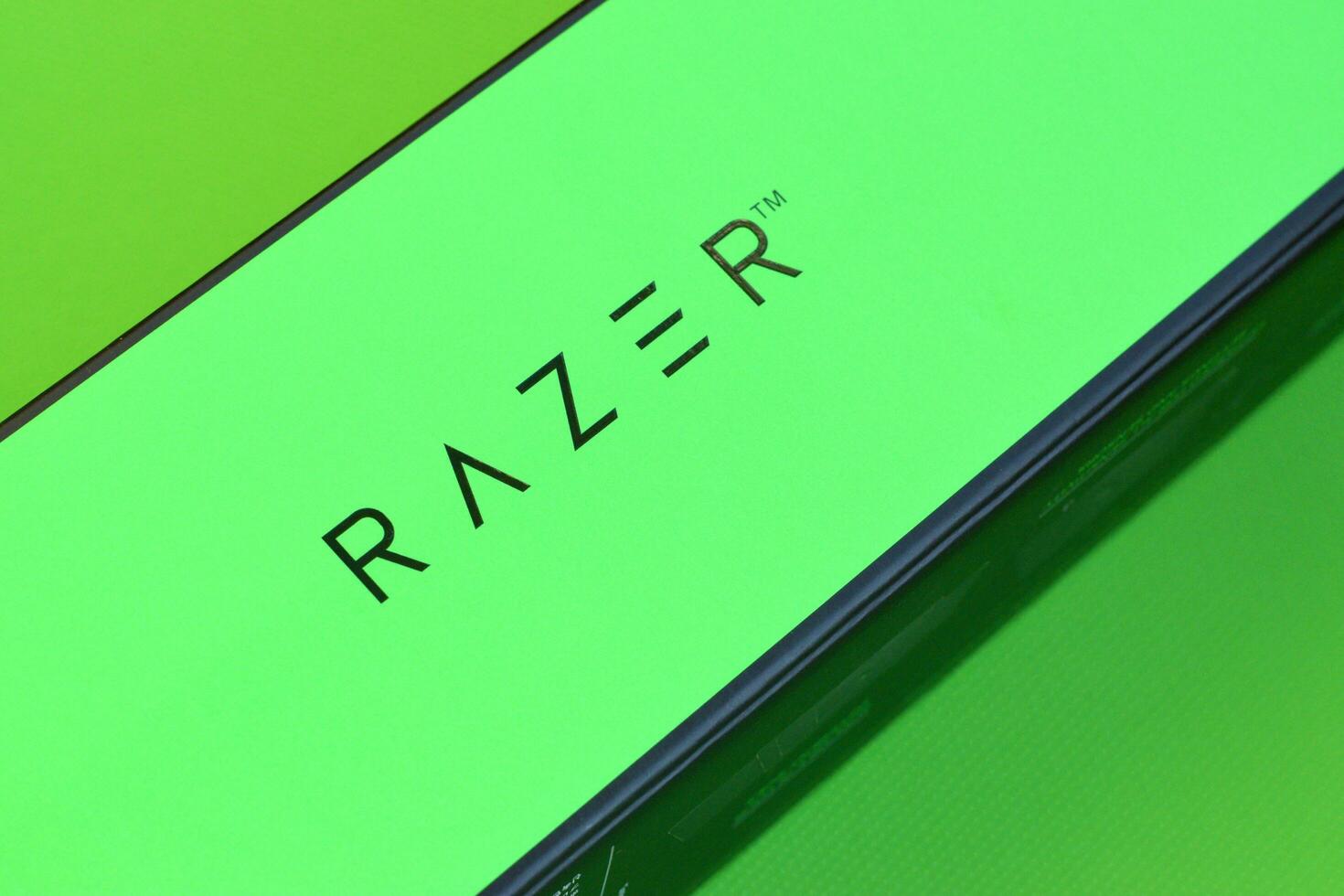 Razer Goliathus Speed Gaming green mouse pad and box with logo. Razer global gaming hardware manufacturing company, as well as an esports and financial services photo