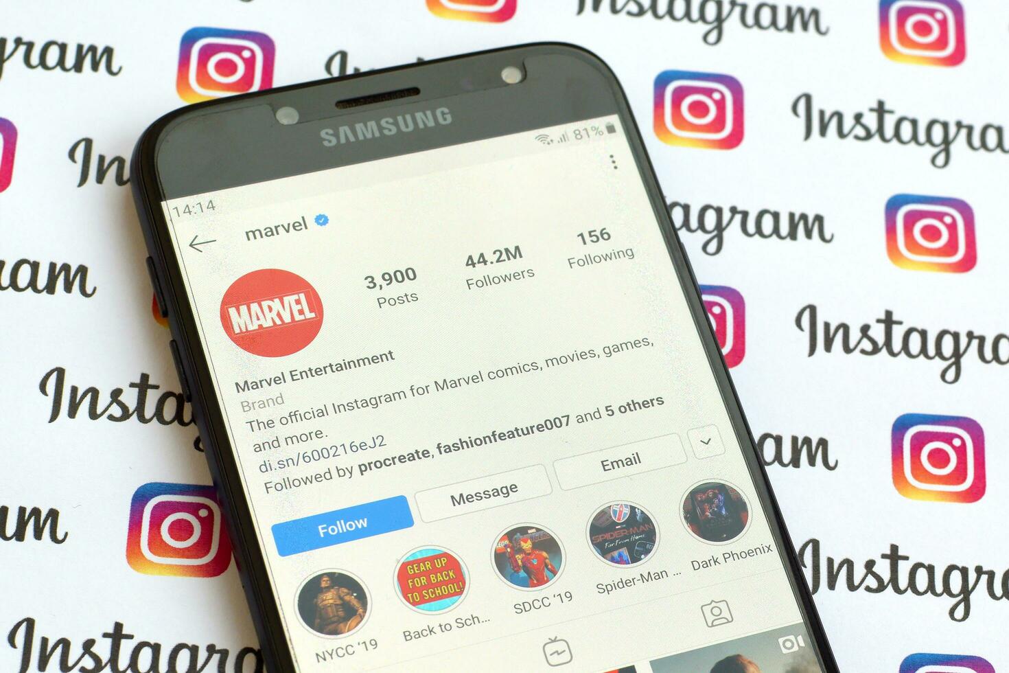 Marvel official instagram account on smartphone screen on paper instagram banner. photo