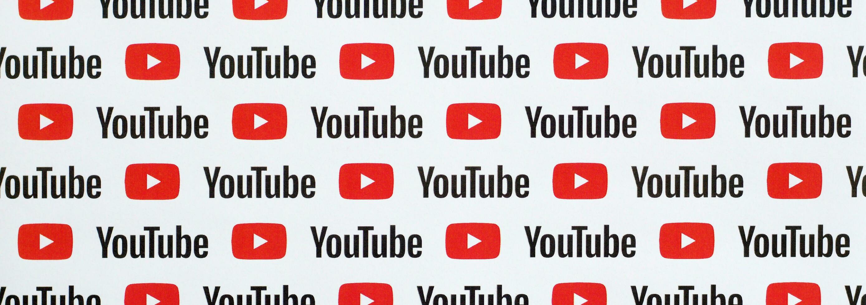 Youtube pattern printed on paper with small youtube logos and inscriptions. YouTube is Google subsidiary and American most popular video-sharing platform photo