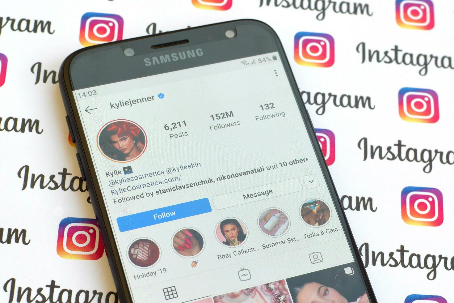 Kylie Jenner official instagram account on smartphone screen on paper instagram banner. photo