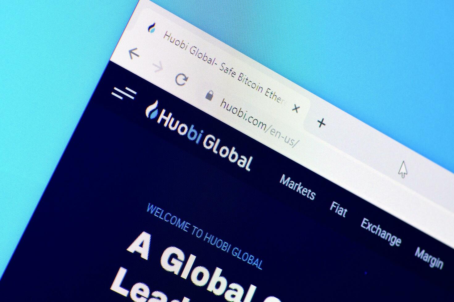 Homepage of huobi website on the display of PC, url - huobi.com. photo