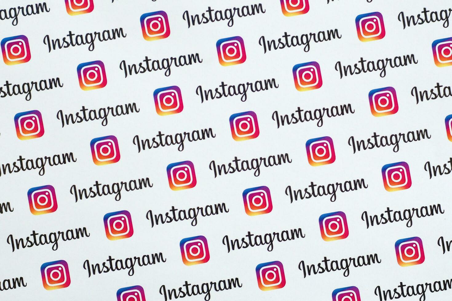 Instagram pattern printed on paper with small instagram logos and inscriptions. Instagram is American photo and video-sharing social networking service owned by Facebook