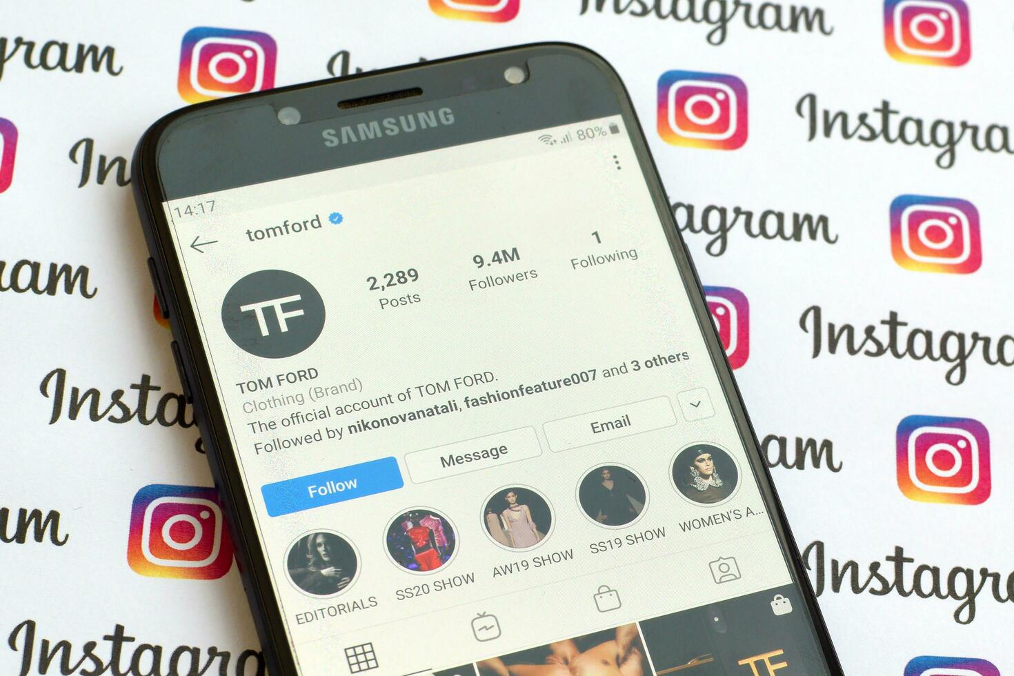Tom Ford official instagram account on smartphone screen on paper instagram banner. photo