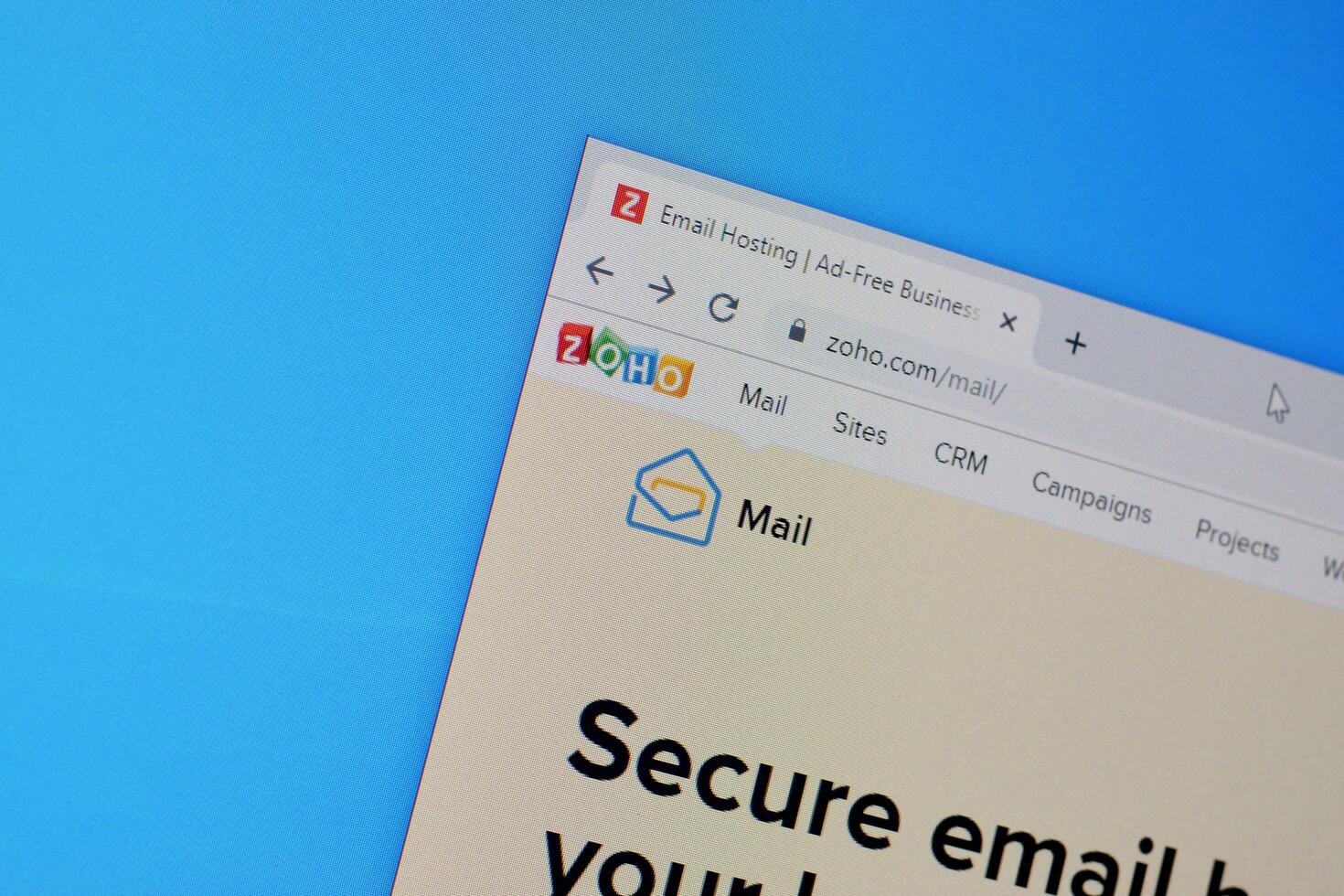 Homepage of zoho mail website on the display of PC, url - www.zoho.com. photo