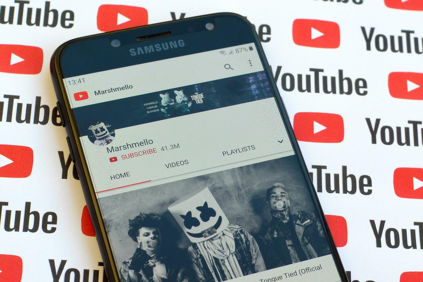 Marshmello official youtube channel on smartphone screen on paper youtube background. photo