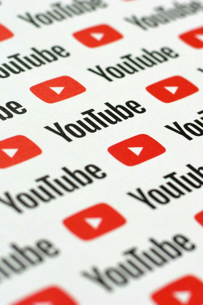 Youtube pattern printed on paper with small youtube logos and inscriptions. YouTube is Google subsidiary and American most popular video-sharing platform photo