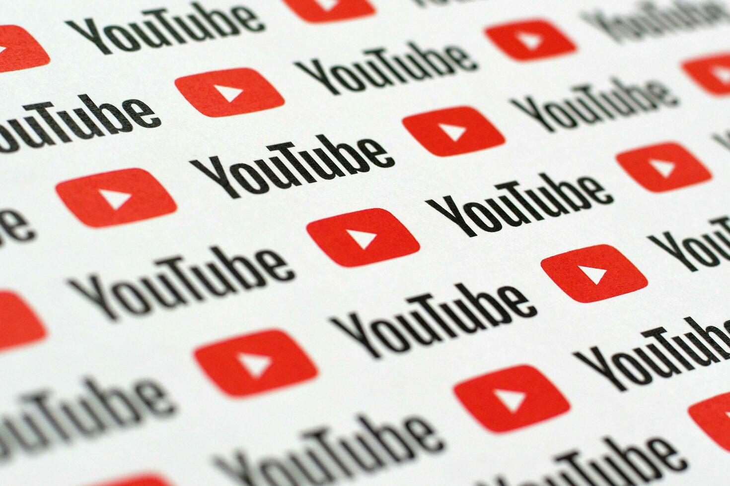 Youtube pattern printed on paper with small youtube logos and inscriptions. YouTube is Google subsidiary and American most popular video-sharing platform photo