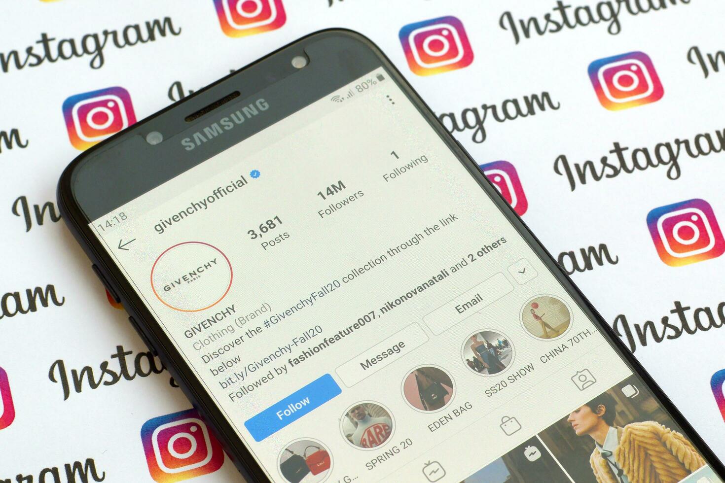 Givenchy official instagram account on smartphone screen on paper instagram banner. photo
