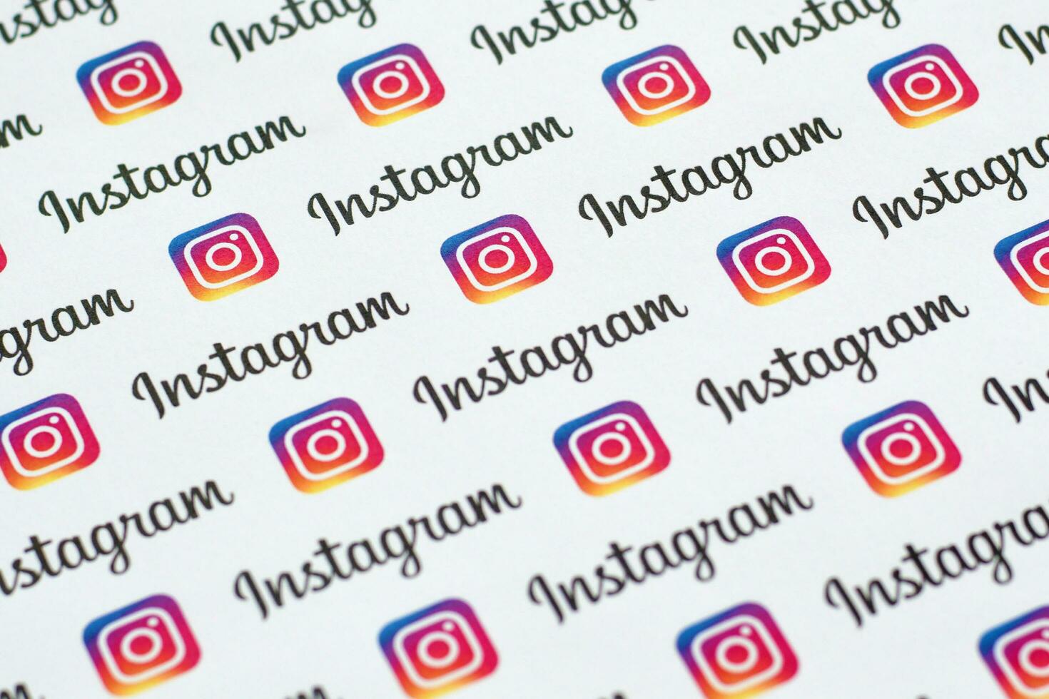 Instagram pattern printed on paper with small instagram logos and inscriptions. Instagram is American photo and video-sharing social networking service owned by Facebook
