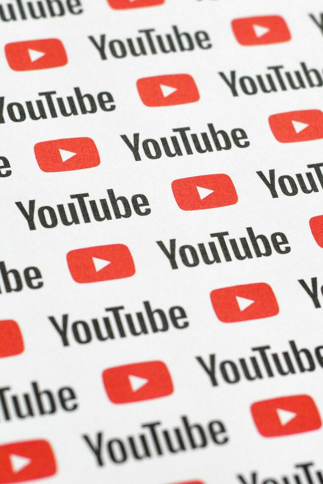 Youtube pattern printed on paper with small youtube logos and inscriptions. YouTube is Google subsidiary and American most popular video-sharing platform photo