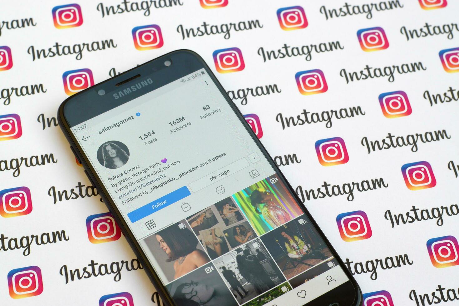 Selena Gomez official instagram account on smartphone screen on paper instagram banner. photo