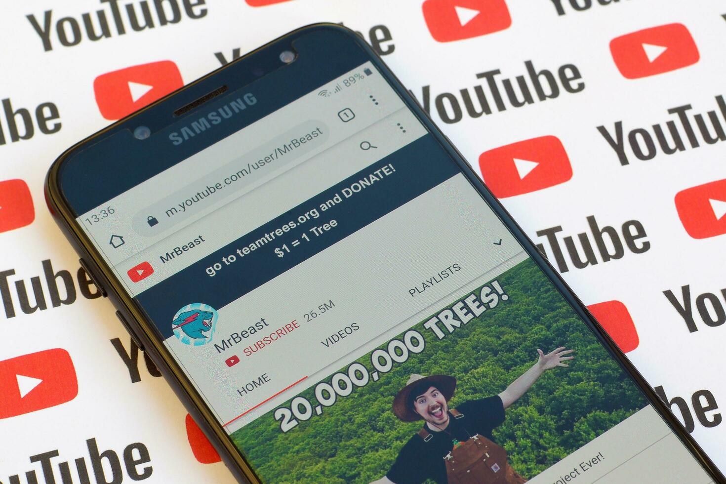 MrBeast official youtube channel on smartphone screen on paper youtube background. photo