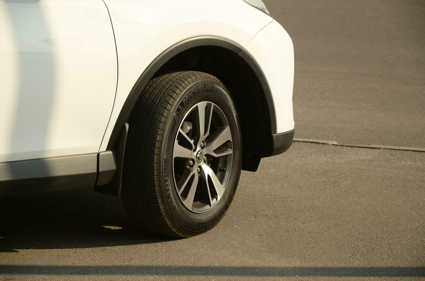 KHARKOV, UKRAINE - OCTOBER 21, 2019 Toyota car wheel with original aluminium rims. Toyota Motor Corporation is a Japanese multinational automotive manufacturer photo