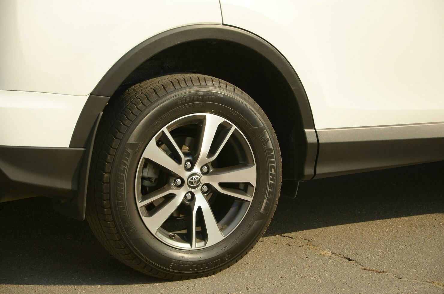 KHARKOV, UKRAINE - OCTOBER 21, 2019 Toyota car wheel with original aluminium rims. Toyota Motor Corporation is a Japanese multinational automotive manufacturer photo