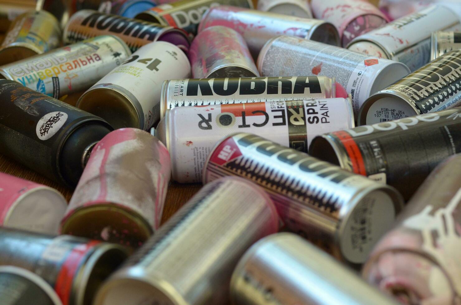 Montana mtn 94 black hardcore dope and kobra used spray cans for graffiti painting lies on wooden background photo
