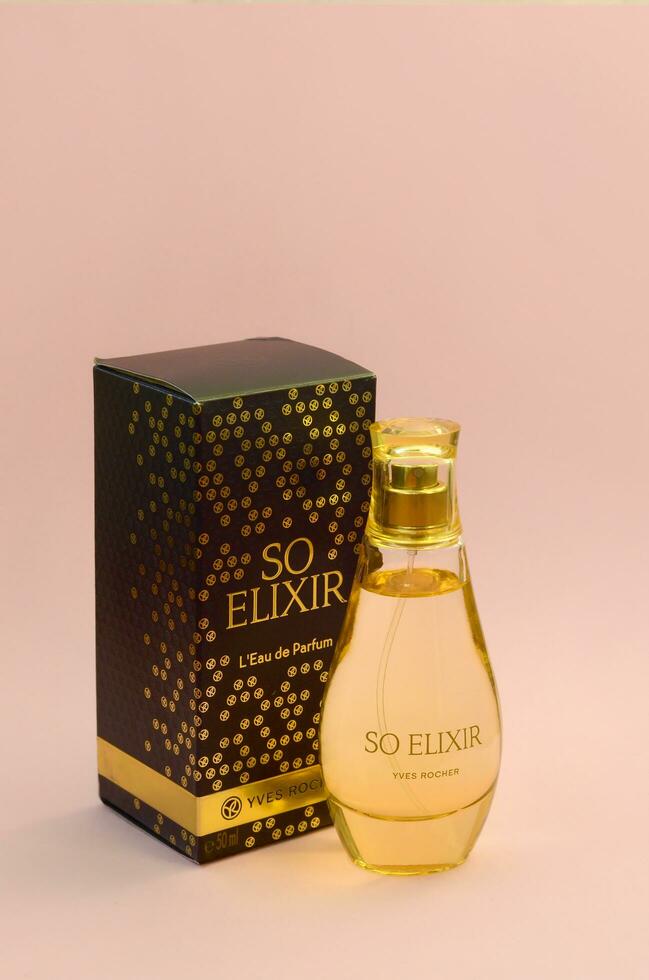 KHARKOV, UKRAINE - OCTOBER 21, 2019 Bottle of So Elixir perfume by Yves Rocher on bright pink color background photo