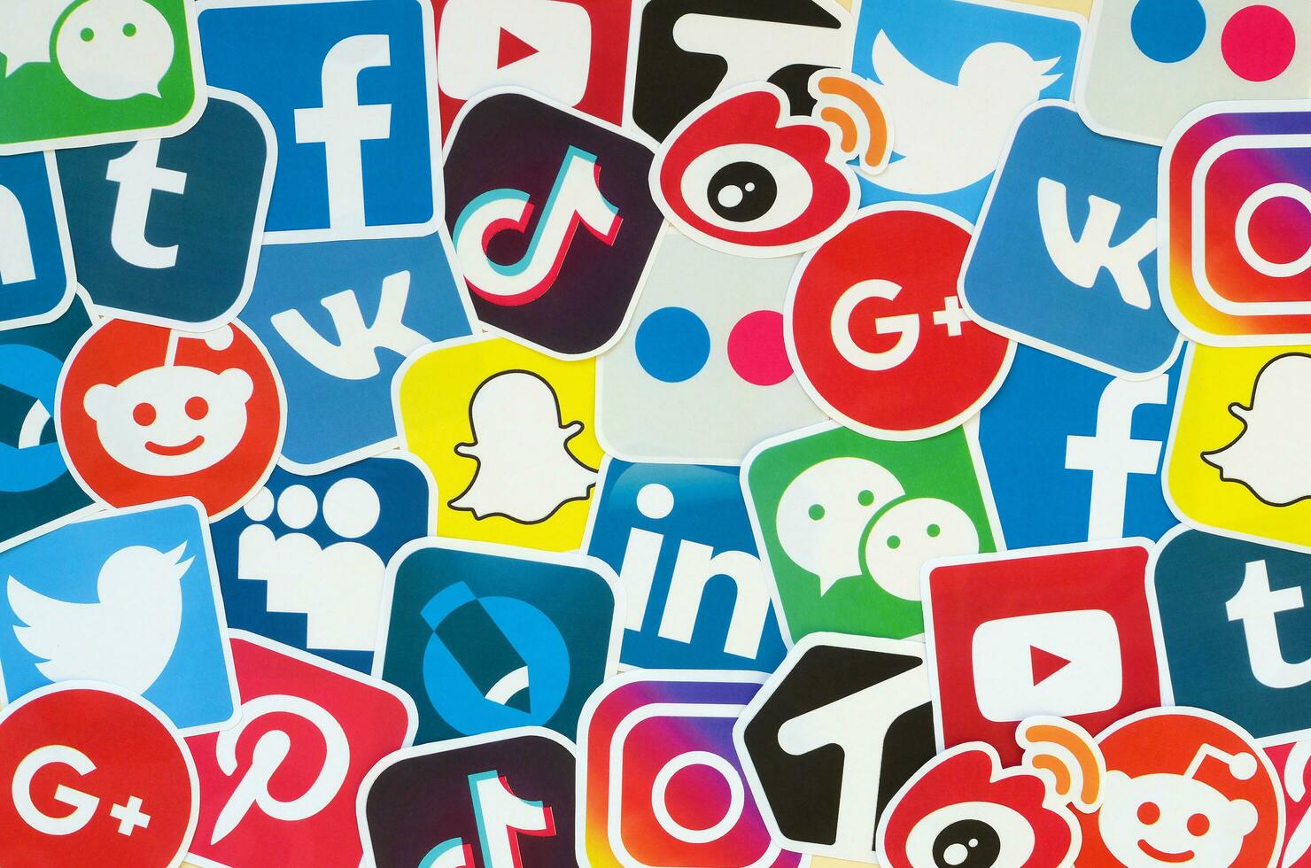 Many paper icons with logo of most popular social networks and smartphone apps for chat and conversations online photo