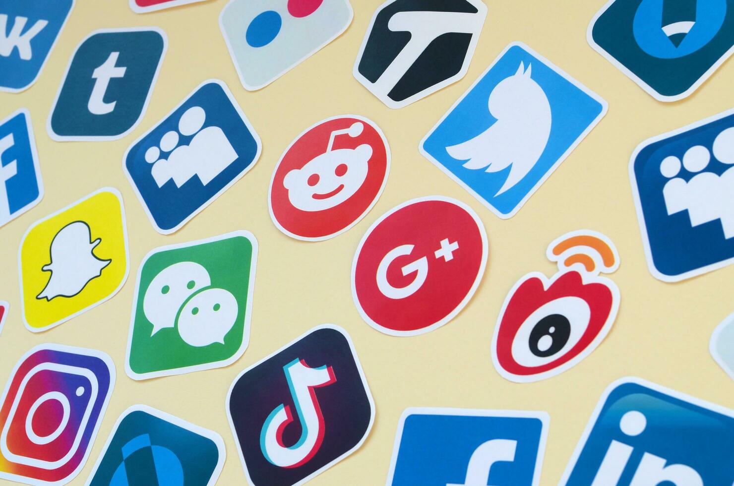 Many paper icons with logo of most popular social networks and smartphone apps for chat and conversations online photo
