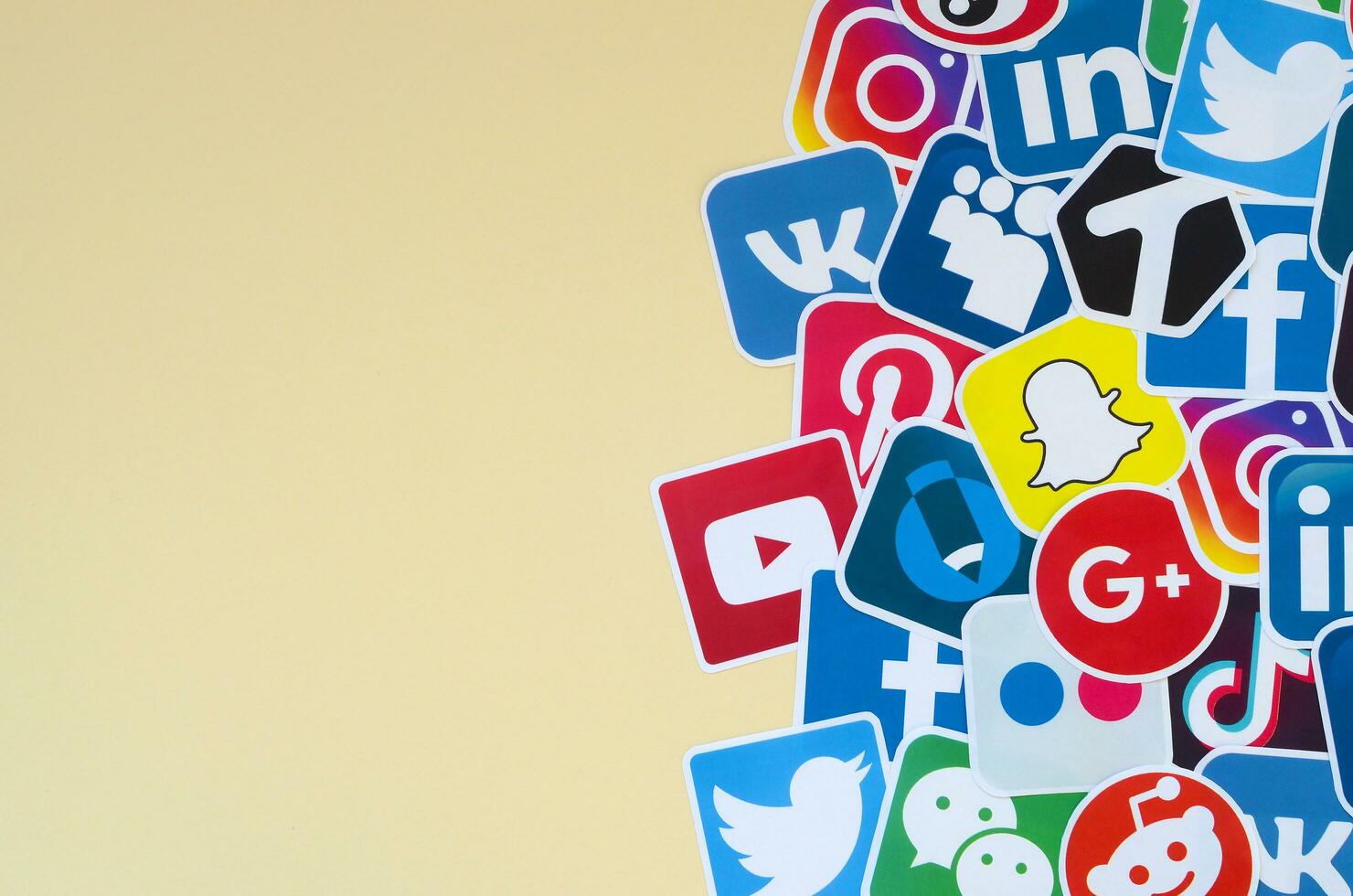 Many paper icons with logo of most popular social networks and smartphone apps for chat and conversations online photo
