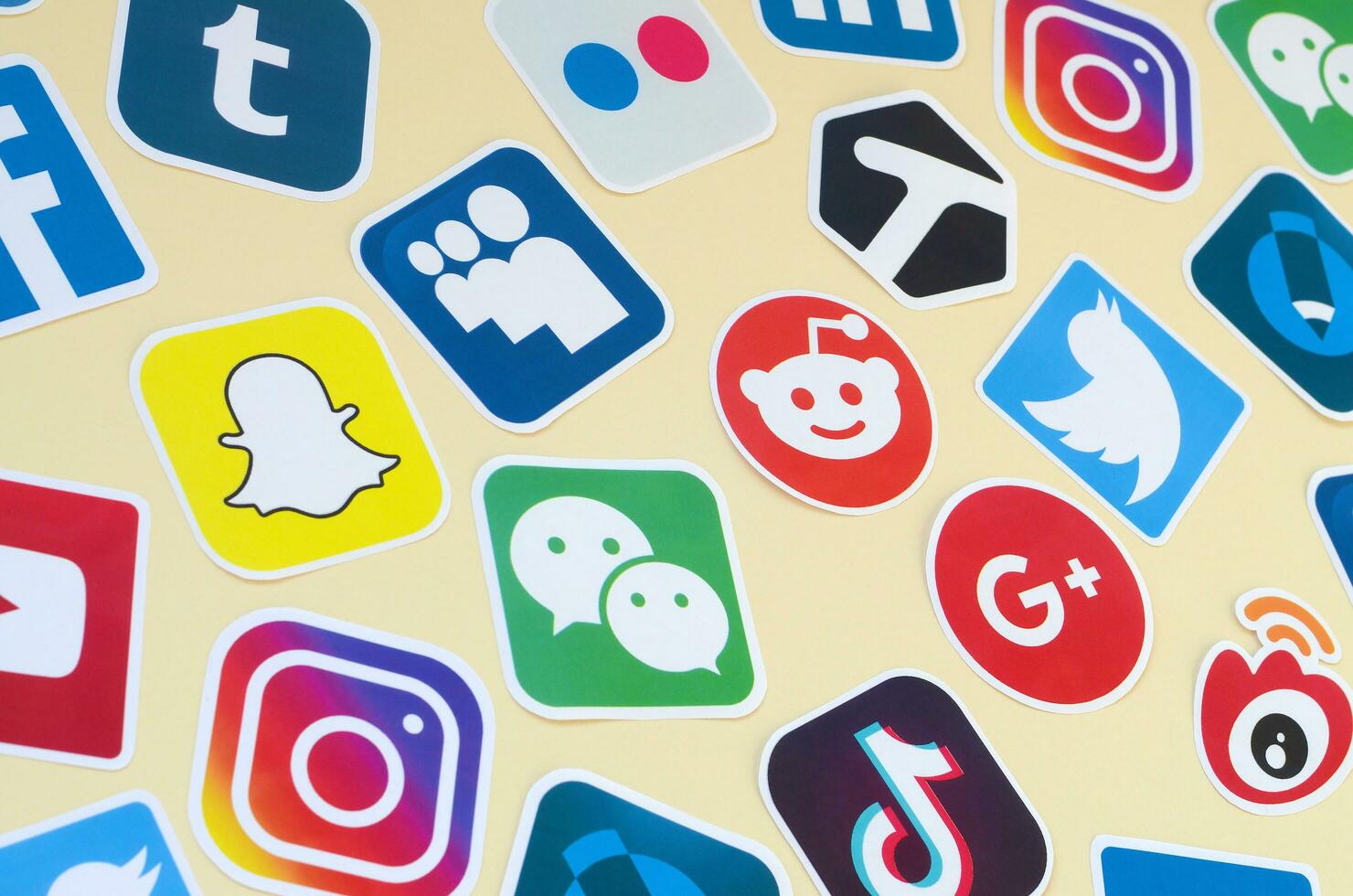 Many paper icons with logo of most popular social networks and smartphone apps for chat and conversations online photo