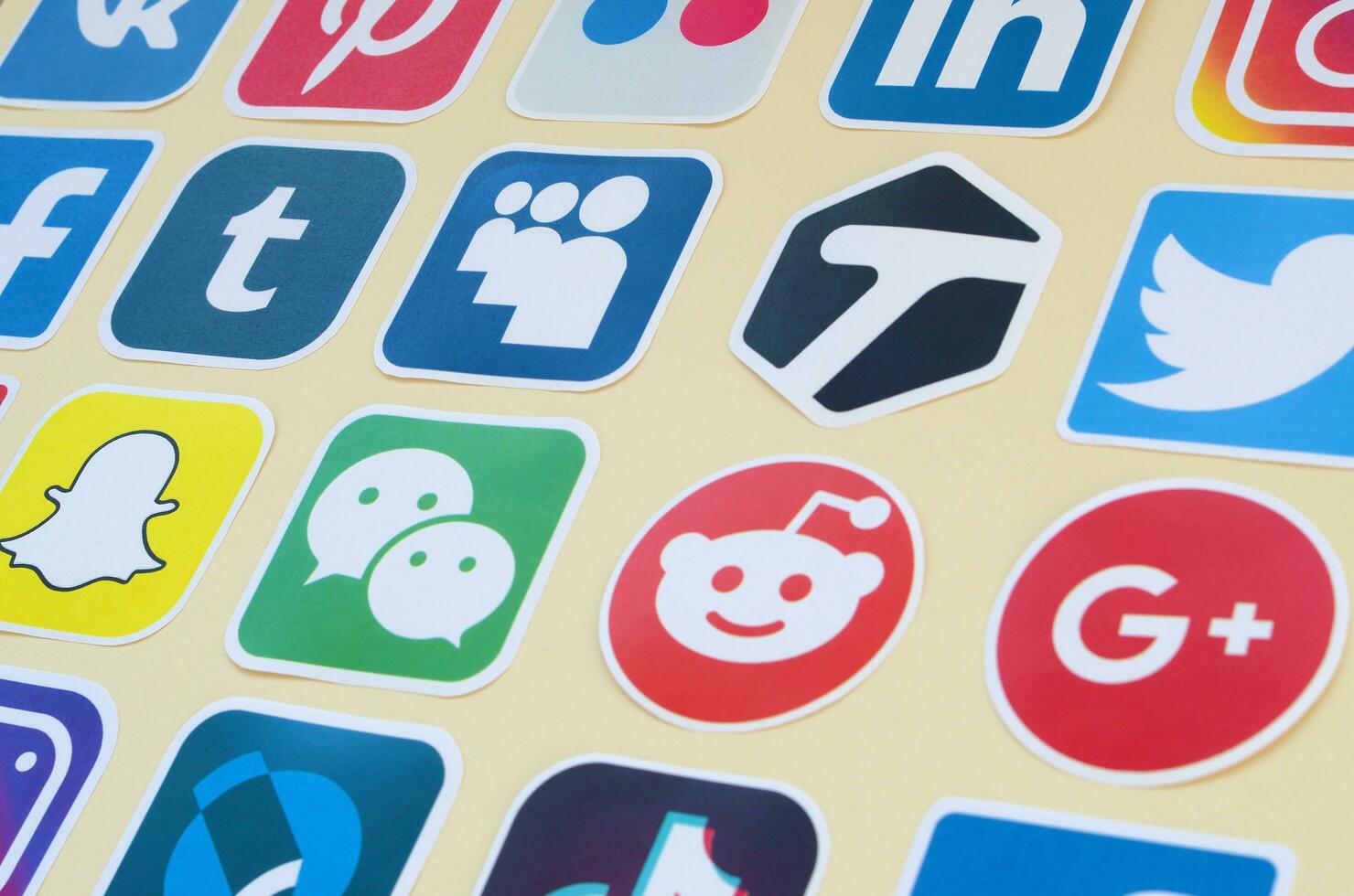 Many paper icons with logo of most popular social networks and smartphone apps for chat and conversations online photo