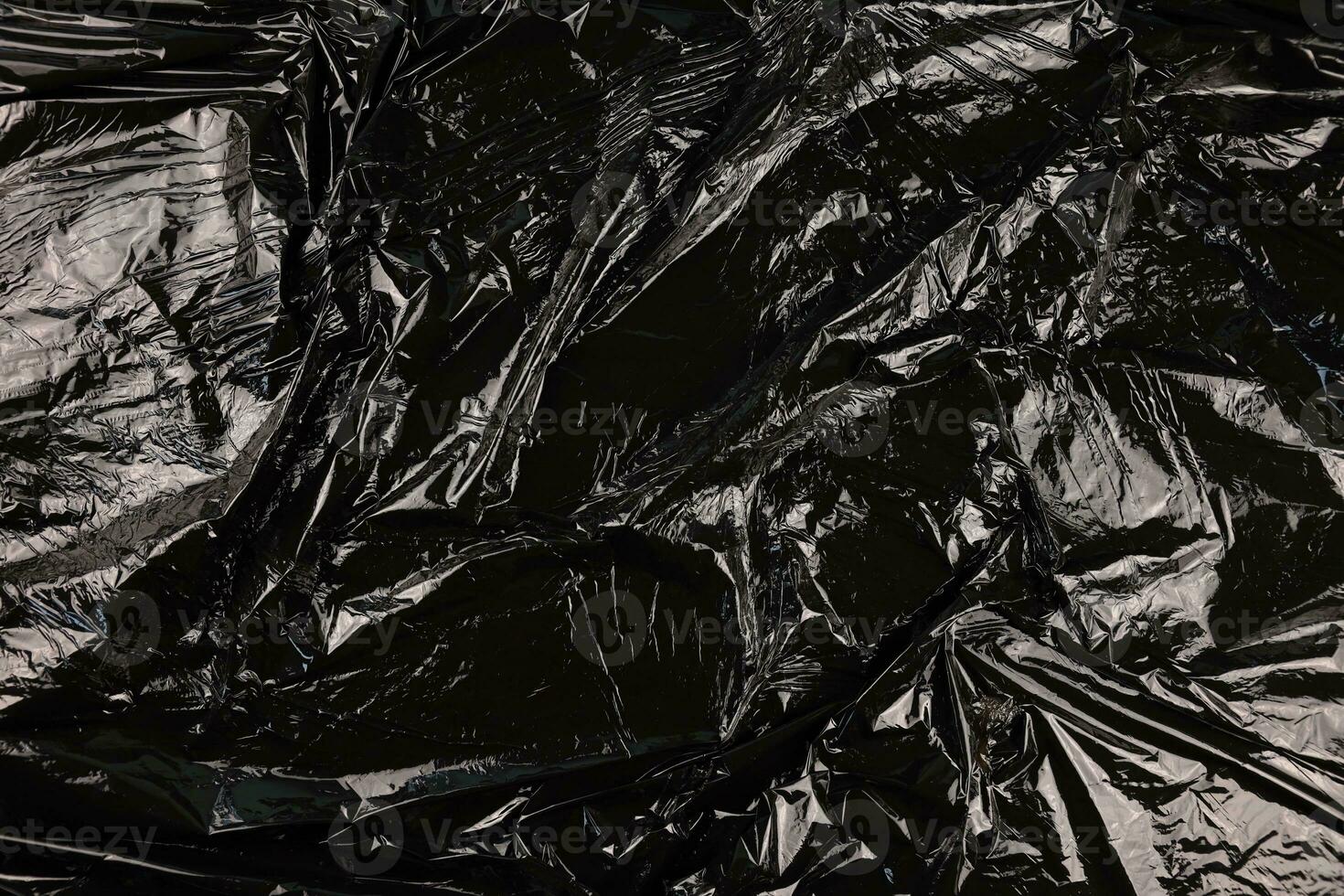 Texture of black plastic garbage disposable bag photo