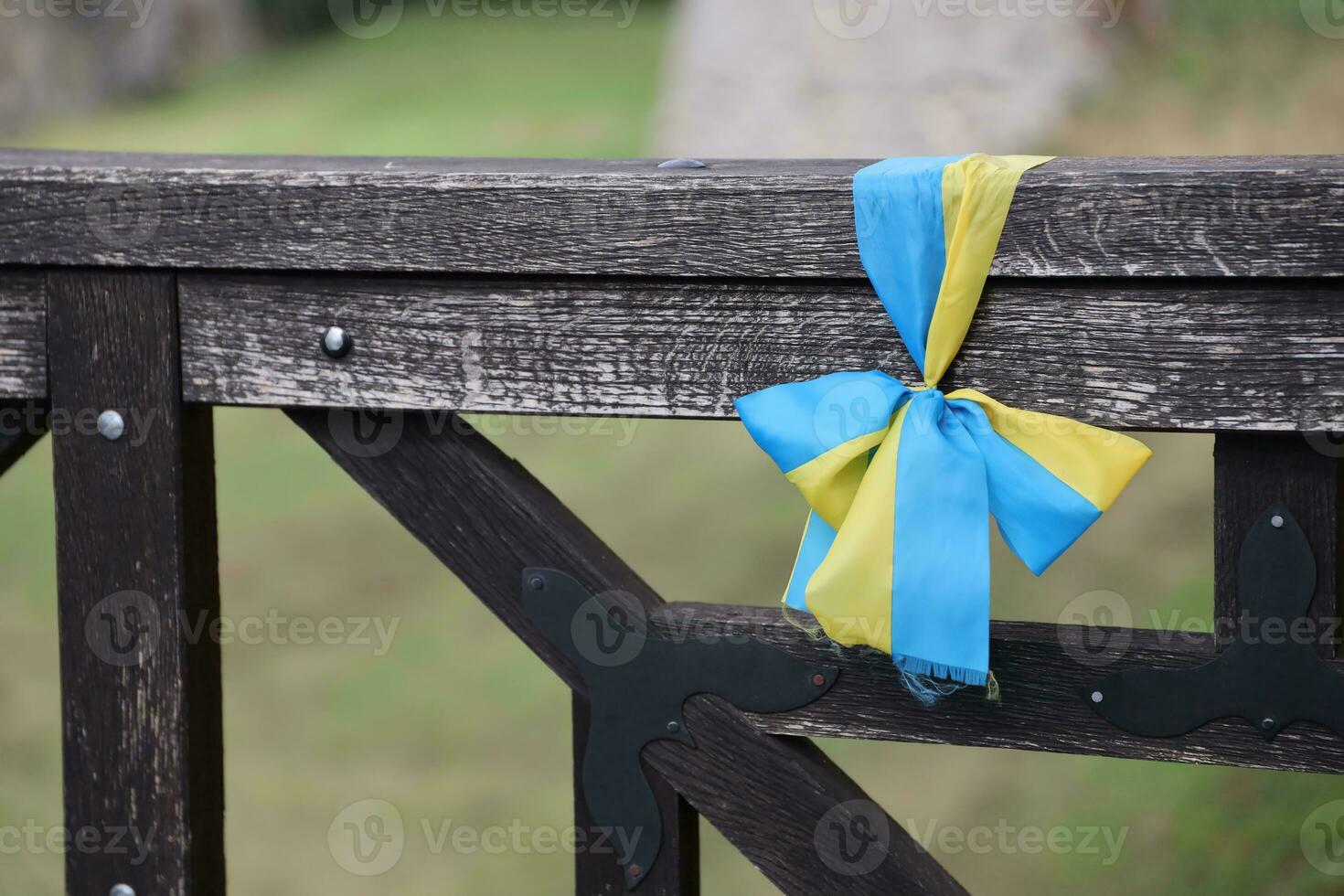 Ribbons in the colors of the national flag of Ukraine are tied to the handrail photo