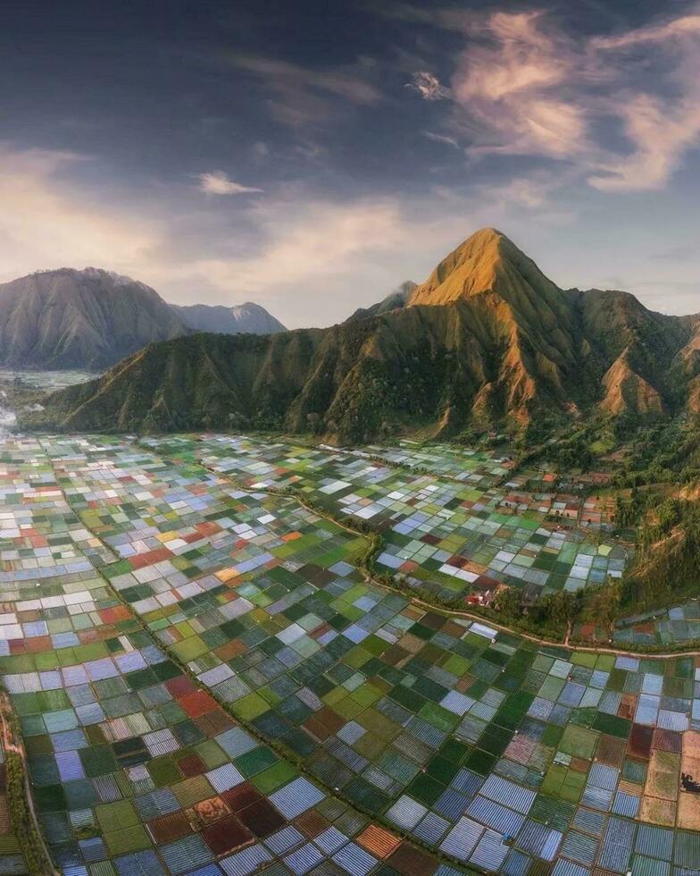 Panoramic Landscape Majestic Mountain Range and Serene Countryside with Picturesque Horizon Expansive scenic landscape with majestic mountains, serene countryside, and dramatic sky. photo