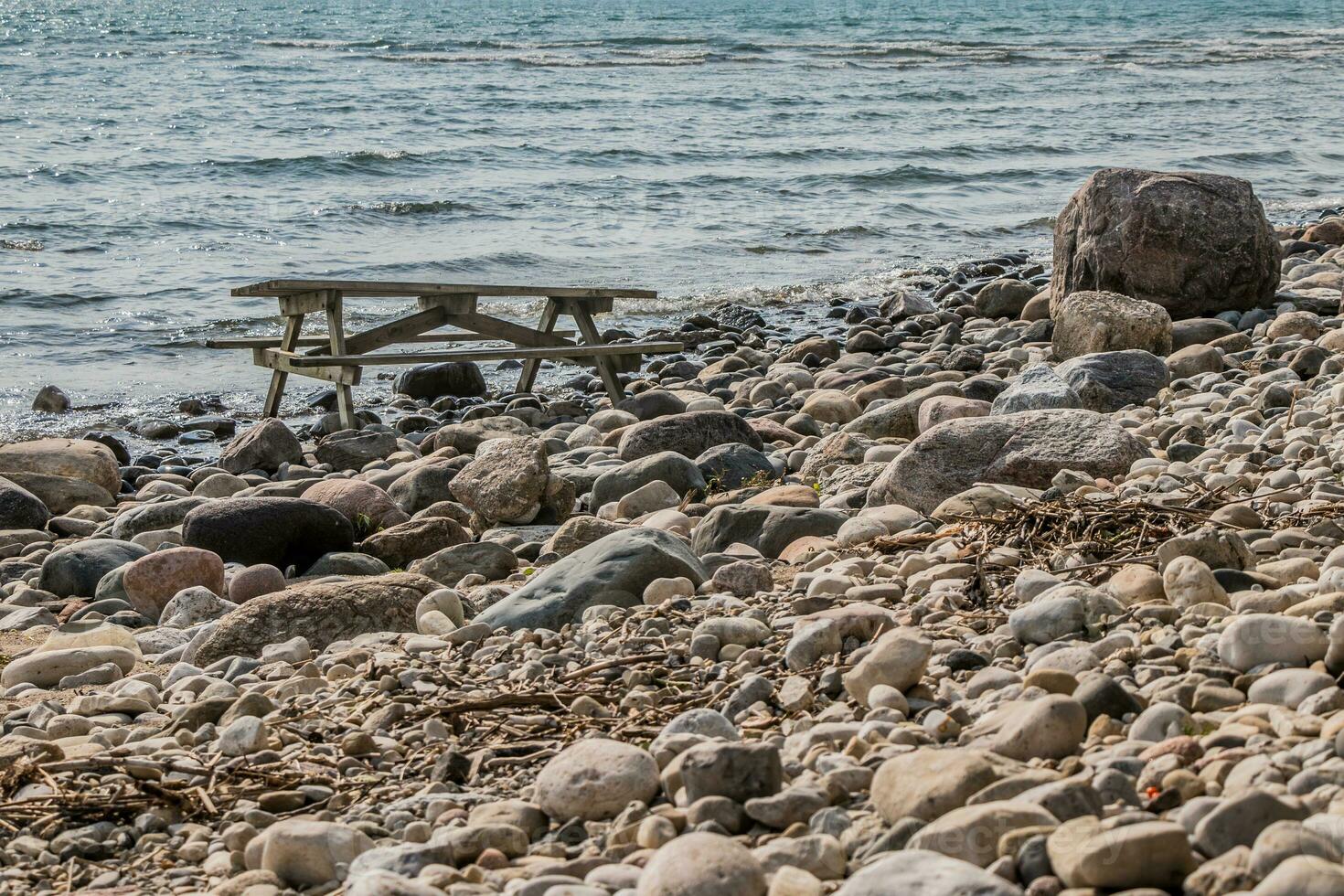Picnic table on a rocky coastline photo