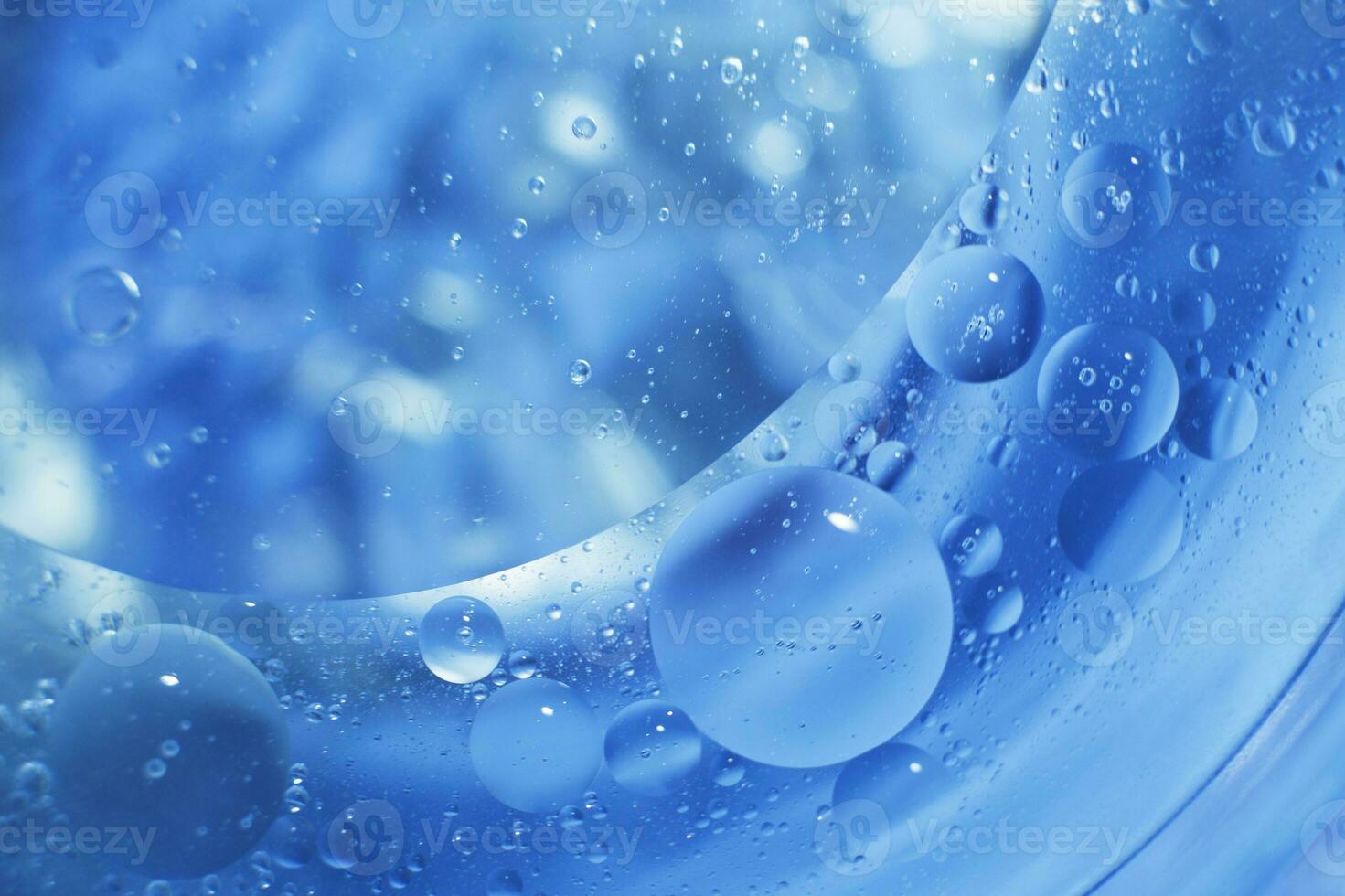 Oil bubbles close up. circles of water macro. abstract light blue background photo