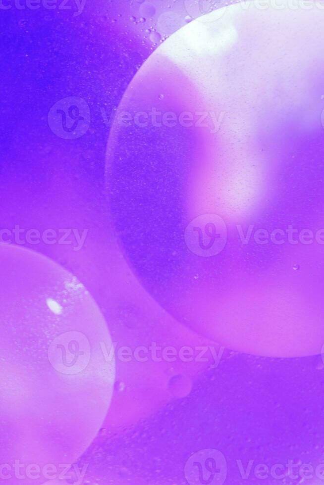 Oil bubbles close up. circles of water macro. abstract light blue background photo